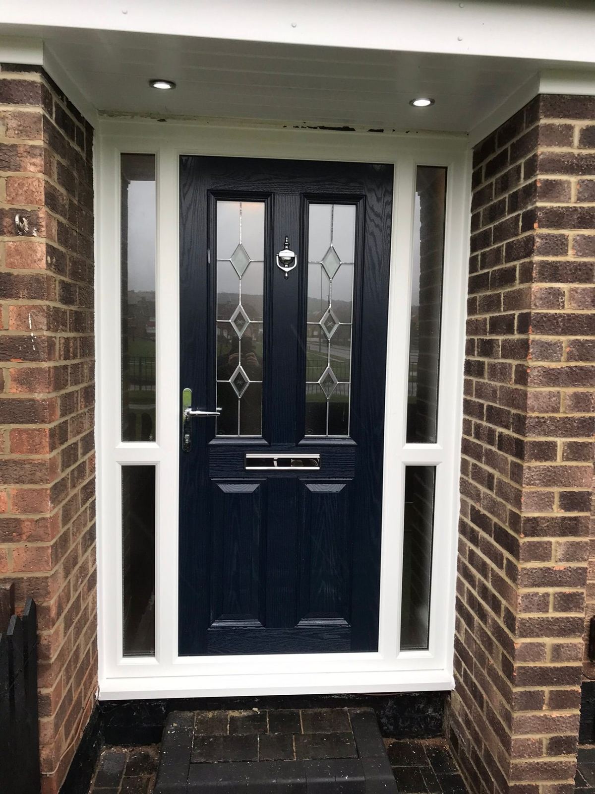 Navy blue composite door with side panels fitted by a trusted installer