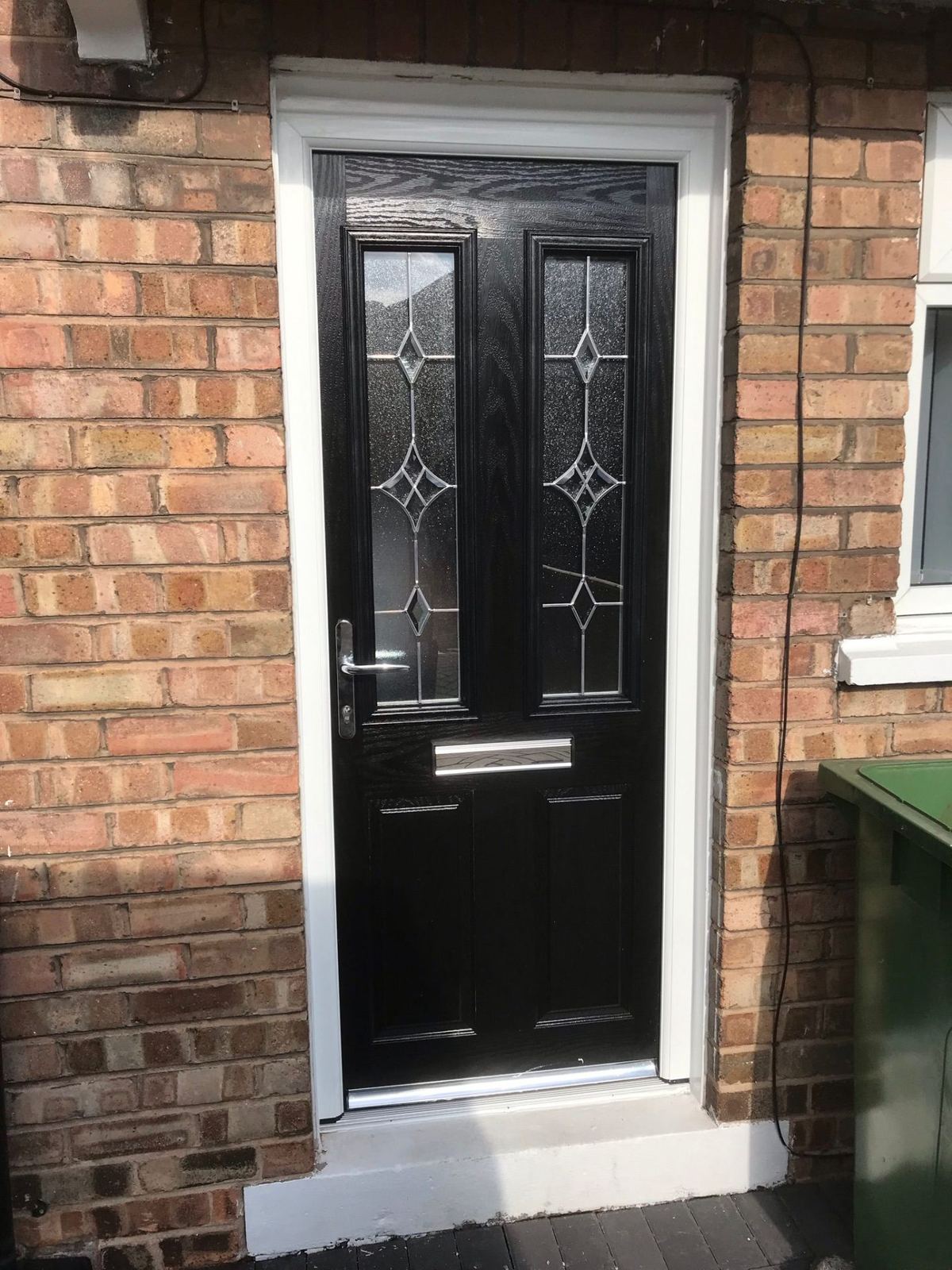 Black composite door with diamond lead glass detail