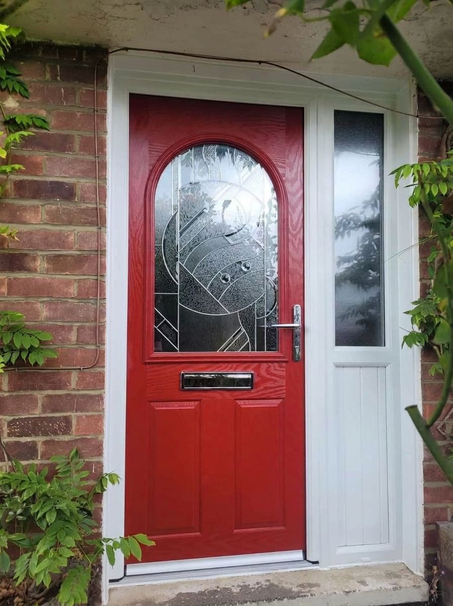 Red composite front door with decorative glass and white side panel