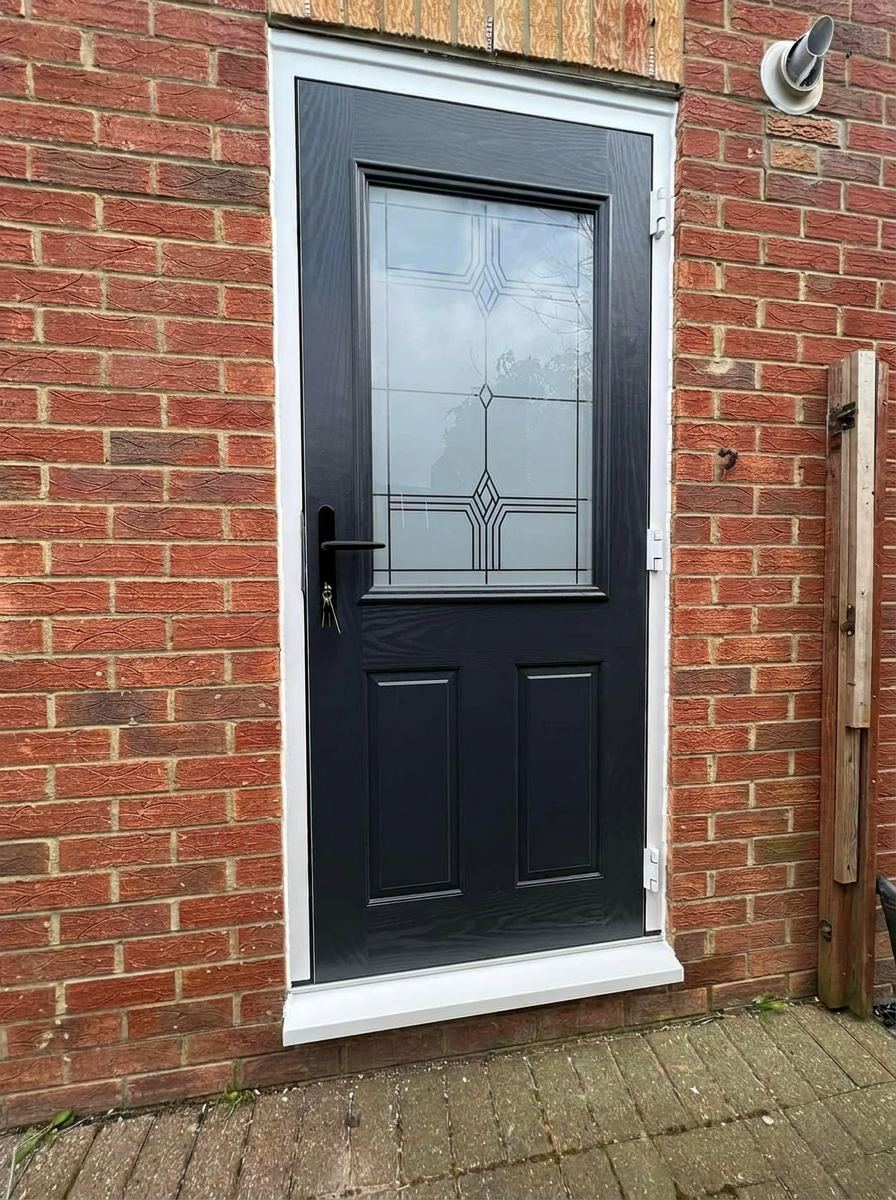 Black composite back door with decorative glass — fitted by a trusted installer