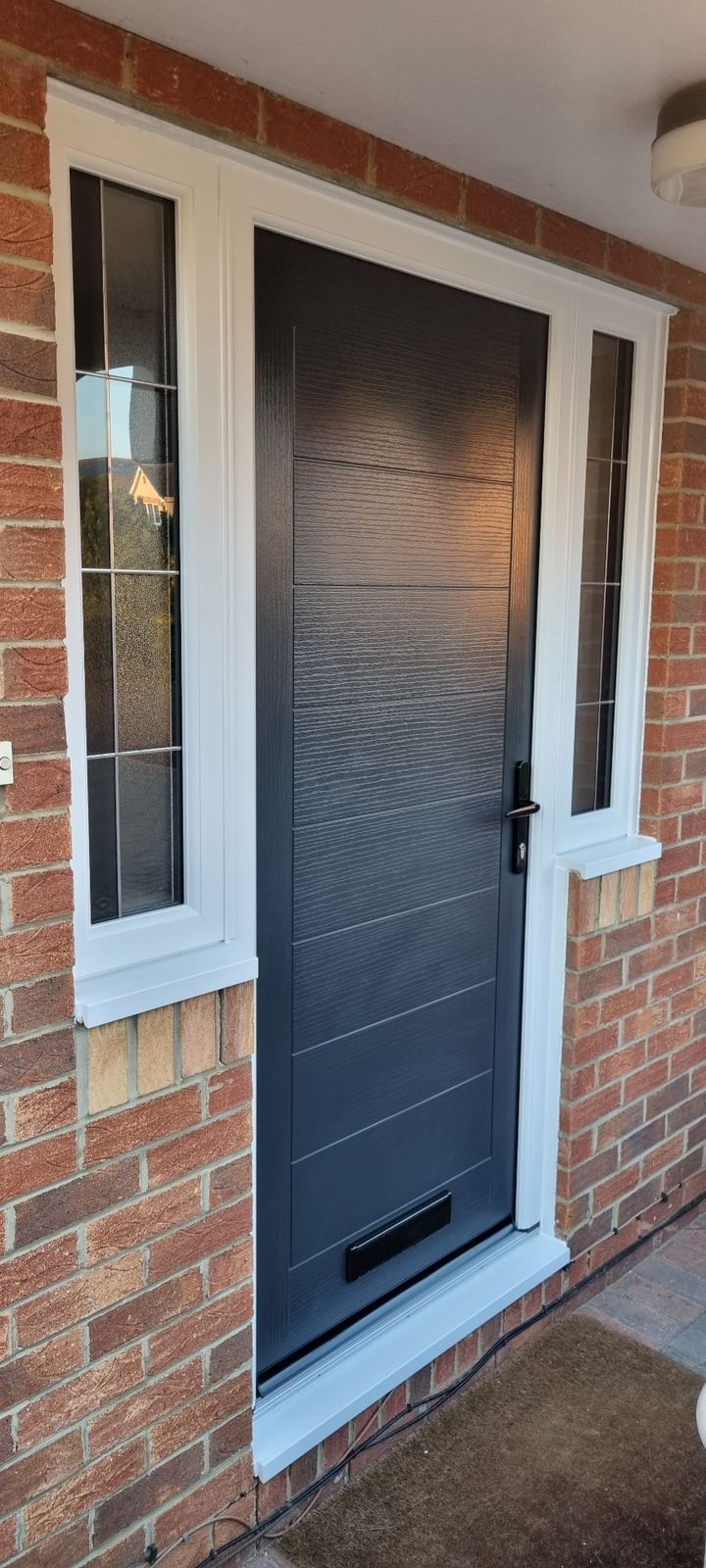 Anthracite grey front door with frosted sidelights