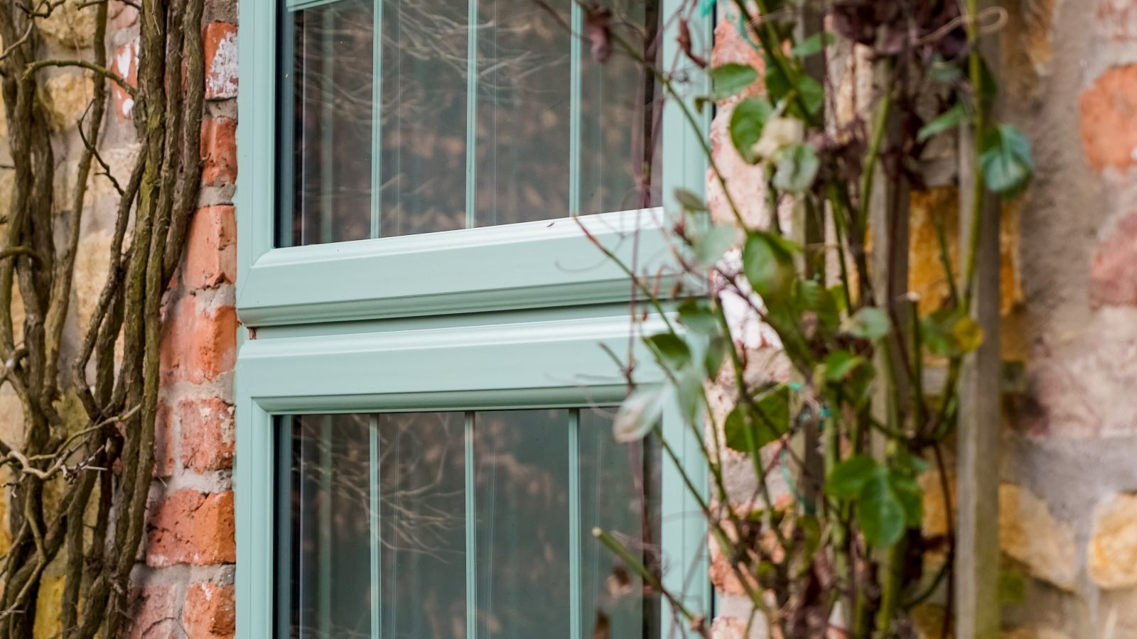 Chartwell Green Liniar 70mm uPVC casement window installed on a red brick home in Teesside