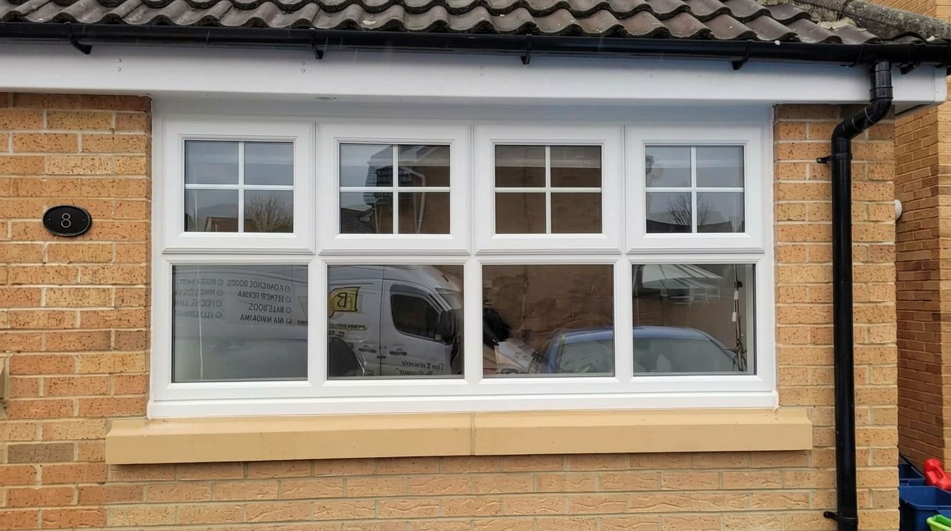 White uPVC cottage window with Georgian bar detailing on a brick bungalow