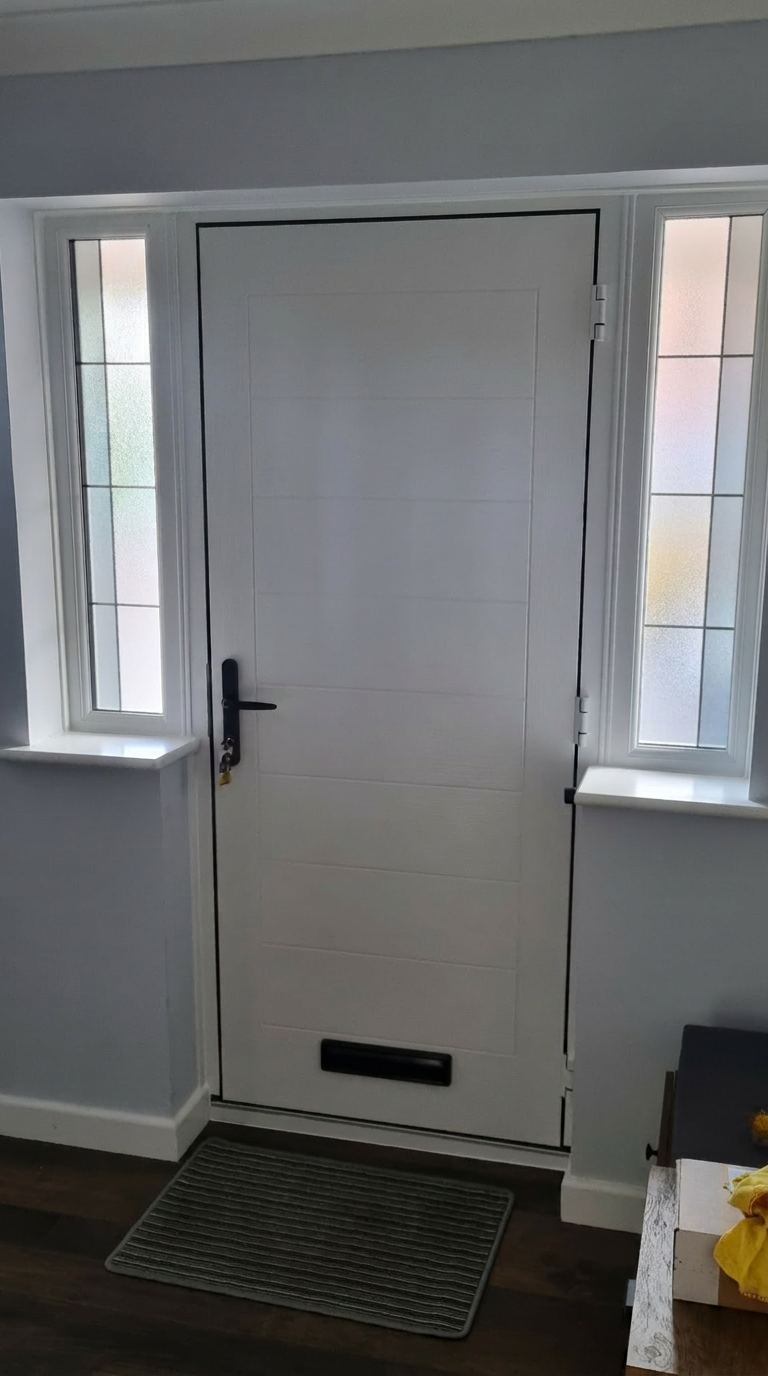 White composite front door with decorative sidelights — interior view