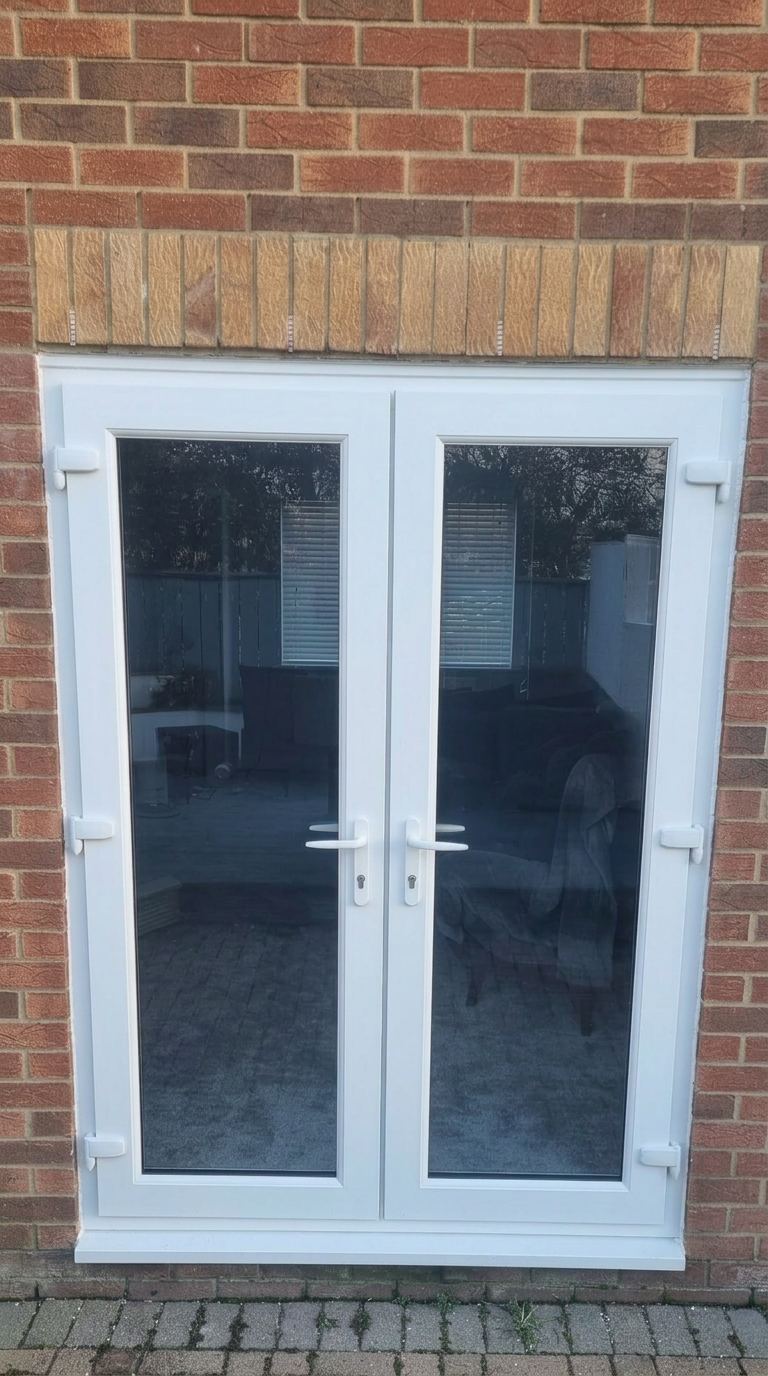 White French doors with dark reflective glazing